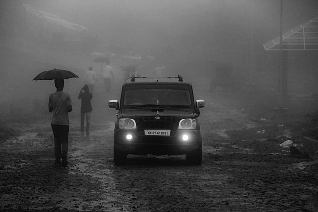 A car running in the rain. Black and white.